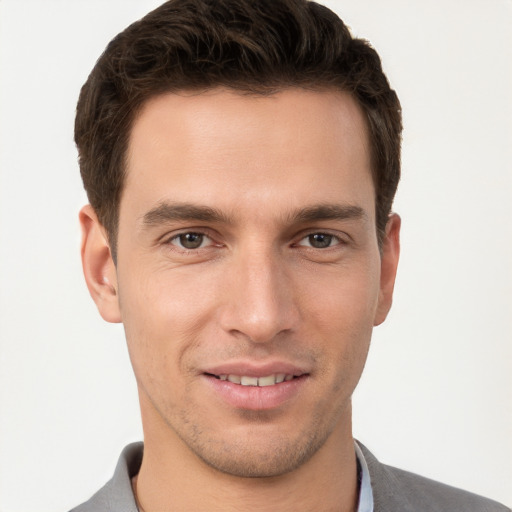 Joyful white young-adult male with short  brown hair and brown eyes