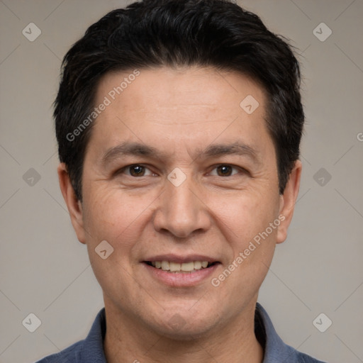 Joyful white adult male with short  black hair and brown eyes