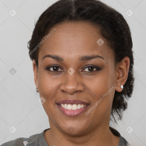 Joyful black adult female with short  brown hair and brown eyes