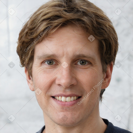 Joyful white adult male with short  brown hair and grey eyes