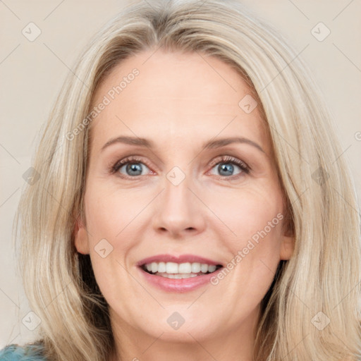 Joyful white adult female with long  brown hair and blue eyes