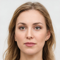 Joyful white young-adult female with long  brown hair and green eyes