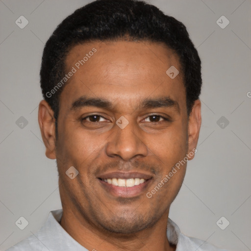 Joyful latino young-adult male with short  black hair and brown eyes