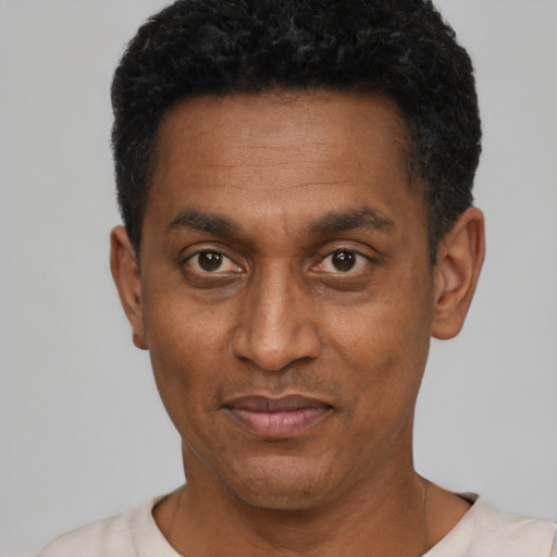 Joyful latino adult male with short  black hair and brown eyes