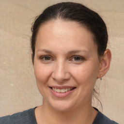 Joyful white adult female with medium  brown hair and brown eyes