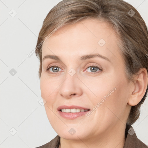 Joyful white adult female with medium  brown hair and grey eyes