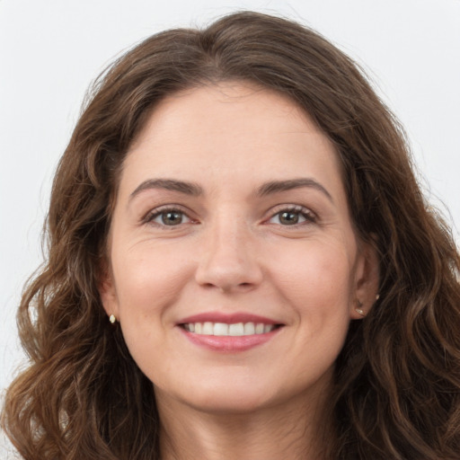 Joyful white young-adult female with long  brown hair and green eyes