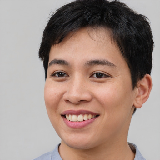 Joyful asian young-adult female with short  brown hair and brown eyes