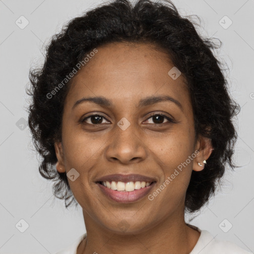 Joyful black young-adult female with long  brown hair and brown eyes