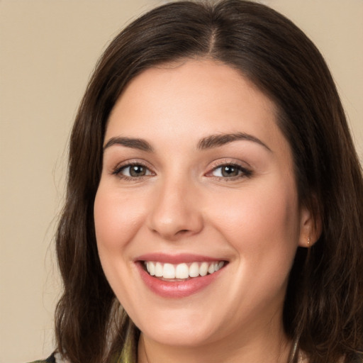 Joyful white young-adult female with long  brown hair and brown eyes