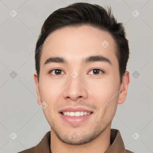 Joyful white young-adult male with short  black hair and brown eyes