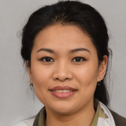 Joyful asian young-adult female with medium  brown hair and brown eyes