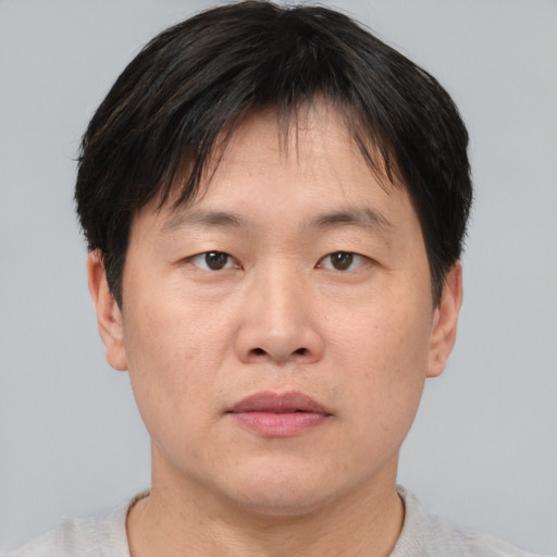 Neutral asian adult male with short  brown hair and brown eyes