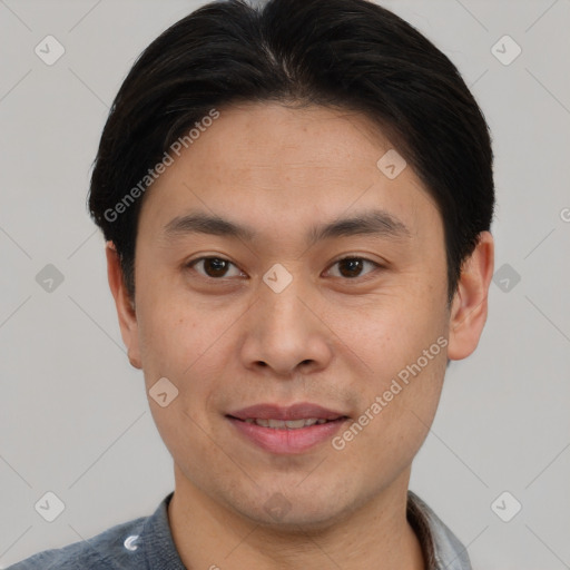 Joyful asian young-adult male with short  brown hair and brown eyes