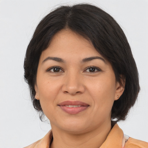 Joyful asian adult female with medium  brown hair and brown eyes