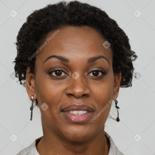 Joyful black adult female with short  brown hair and brown eyes