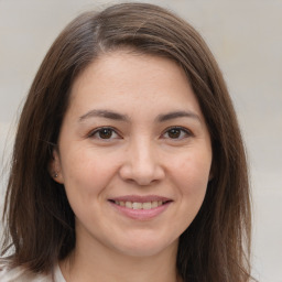 Joyful white young-adult female with medium  brown hair and brown eyes