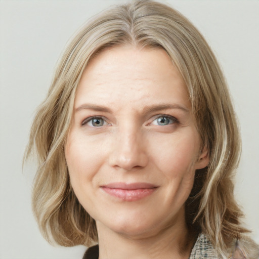 Joyful white young-adult female with medium  brown hair and blue eyes