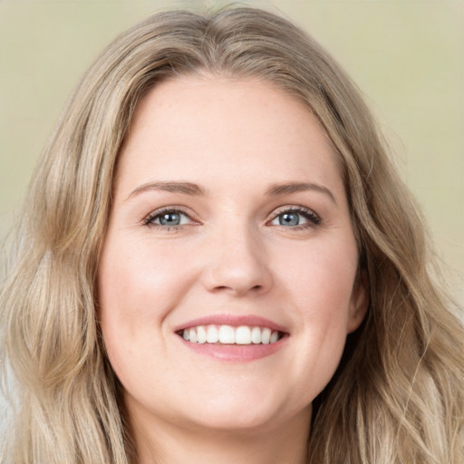 Joyful white young-adult female with long  brown hair and green eyes