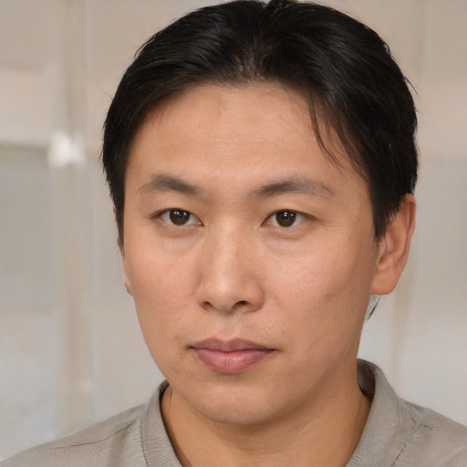 Neutral asian young-adult male with short  brown hair and brown eyes