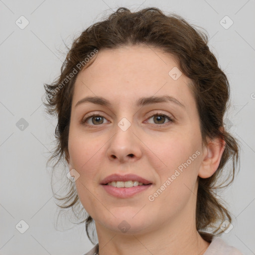 Joyful white young-adult female with medium  brown hair and green eyes