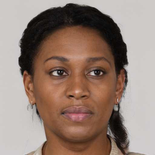 Joyful black adult female with short  brown hair and brown eyes