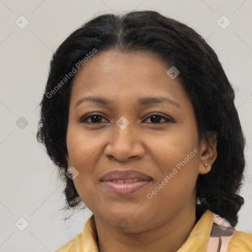 Joyful black adult female with medium  brown hair and brown eyes