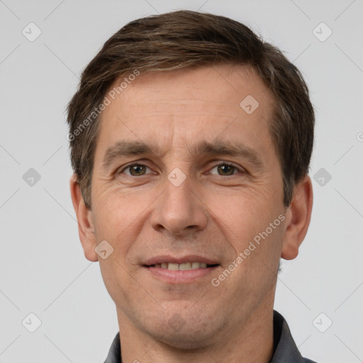 Joyful white adult male with short  brown hair and grey eyes