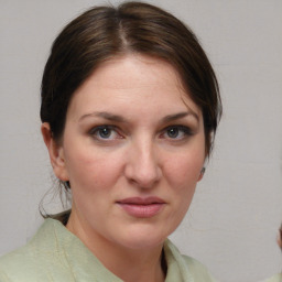 Joyful white adult female with medium  brown hair and brown eyes