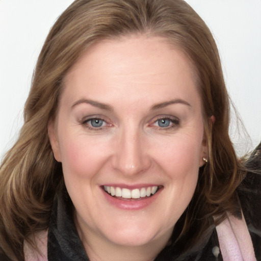 Joyful white adult female with long  brown hair and grey eyes