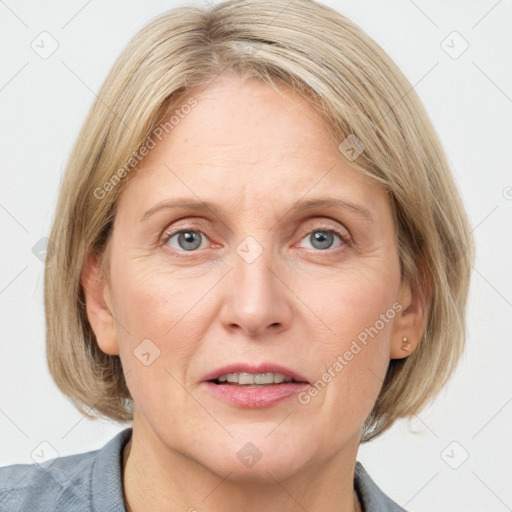 Joyful white adult female with medium  brown hair and blue eyes