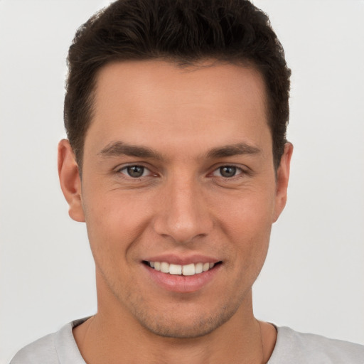 Joyful white young-adult male with short  brown hair and brown eyes