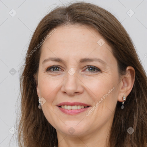 Joyful white adult female with long  brown hair and grey eyes