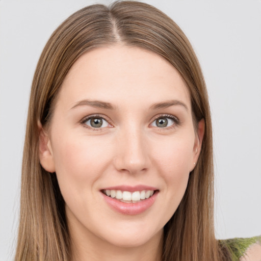 Joyful white young-adult female with long  brown hair and grey eyes