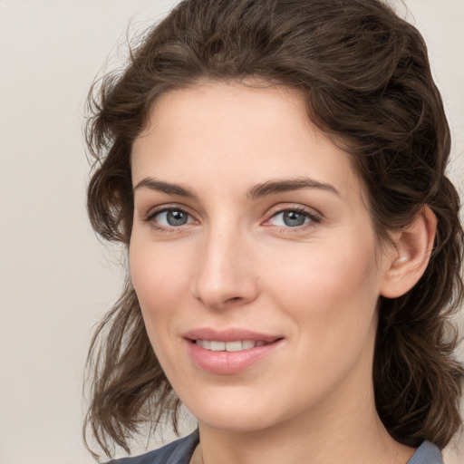 Joyful white young-adult female with medium  brown hair and blue eyes