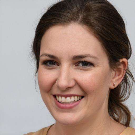 Joyful white young-adult female with medium  brown hair and brown eyes