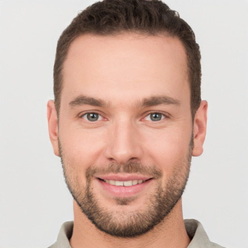 Joyful white young-adult male with short  brown hair and brown eyes