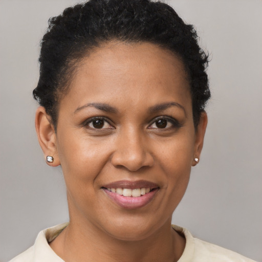 Joyful black young-adult female with short  brown hair and brown eyes