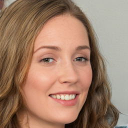 Joyful white young-adult female with long  brown hair and green eyes