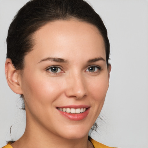 Joyful white young-adult female with medium  brown hair and brown eyes