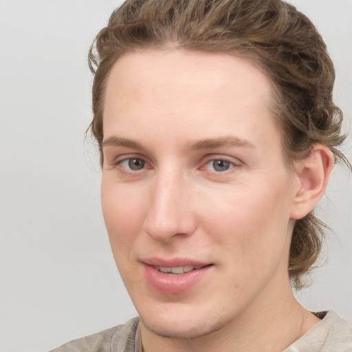 Joyful white young-adult female with medium  brown hair and blue eyes