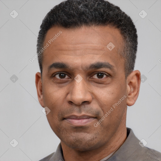 Joyful latino adult male with short  black hair and brown eyes