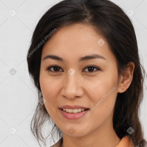 Joyful latino young-adult female with medium  brown hair and brown eyes