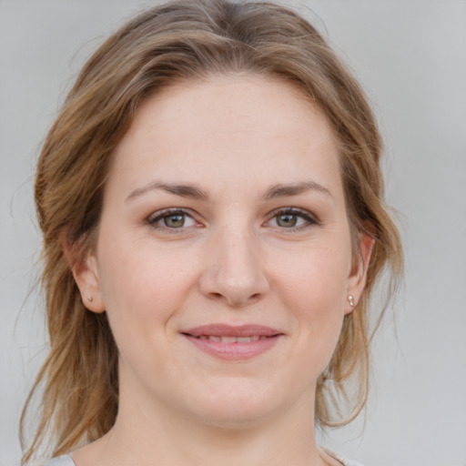 Joyful white young-adult female with medium  brown hair and blue eyes