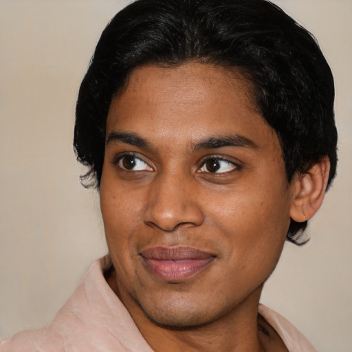 Joyful black young-adult male with short  black hair and brown eyes