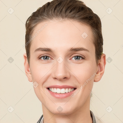 Joyful white young-adult female with short  brown hair and grey eyes