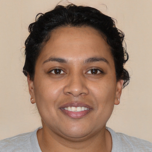 Joyful latino young-adult female with short  brown hair and brown eyes