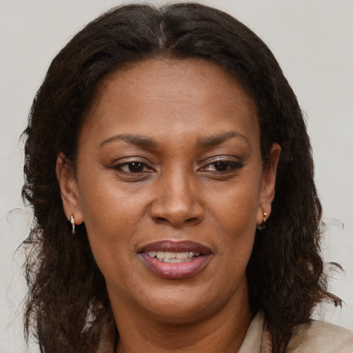 Joyful black adult female with medium  brown hair and brown eyes