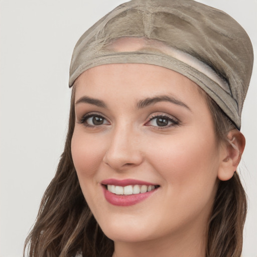 Joyful white young-adult female with long  brown hair and grey eyes