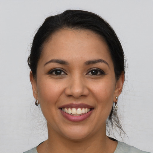 Joyful latino young-adult female with short  brown hair and brown eyes